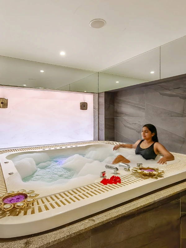 Jacuzzi & Spa – Luxury Wellness at Orchid Hotel Panchgani Luxury jacuzzi with bubble bath and flower petals at Orchid Hotel Panchgani spa and wellness centre