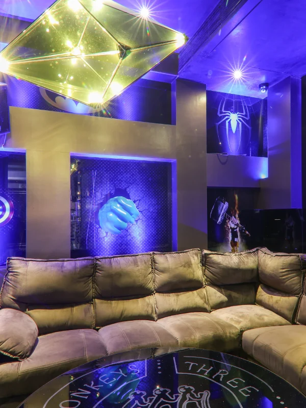 Themed Lounge Bar – Nightlife at Orchid Hotel Panchgani Themed lounge bar with neon blue lighting, plush sofas, and entertainment wall at Orchid Hotel Panchgani