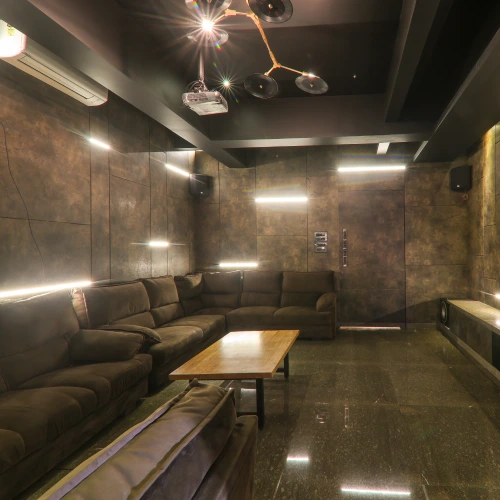 Cinema Room – Orchid Panchgani Entertainment Private cinema room with projector and plush sofas at Orchid Hotel Panchgani