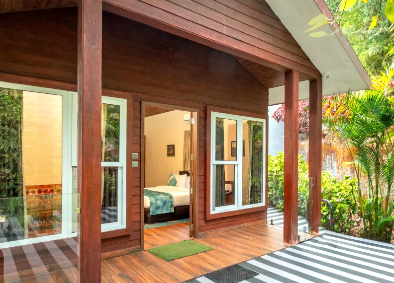 Wooden Cottage Suite Exterior & Porch - Orchid Hotel Panchgani Exterior porch entrance of 350 sqft Wooden Cottage Suite surrounded by tropical garden at Orchid Hotel Panchgani